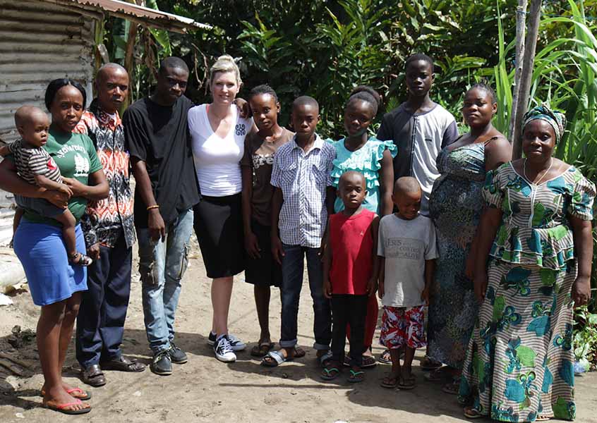 MiaDonna CEO Anna-Mieke Anderson stands with Ponpon and 11 members of his family, beneficiaries of The Greener Diamond Ponpon family scholarship