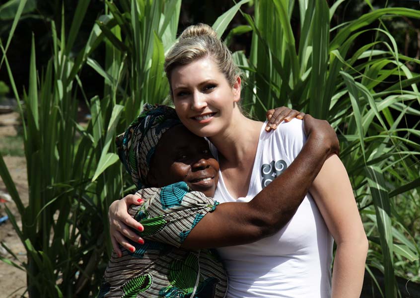 MiaDonna founder Anna-Mieke Anderson and Ponpon's smiling mother hug at the site of a The Greener Diamond farm in Liberia.