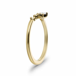 Diamond accented contour wedding band with sculptural inspired designs in 14k yellow gold shown from side