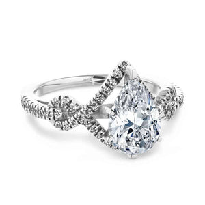  two tone engagement ring Shown with a 1.0ct Pear cut Lab-Grown Diamond with a diamond accented halo and twisted detail band in recycled 14K white