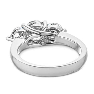 Three stone engagement ring with trellis set round cut lab grown diamonds in 14k white gold shown from back