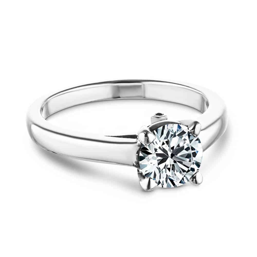 Shown with 1ct Round Cut Lab Grown Diamond in 14k White Gold|Simple traditional solitaire engagement ring with peek-a-boo diamond and 1ct round cut lab created diamond set in 14k recycled white gold