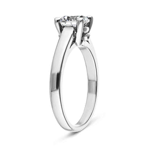 Simple solitaire engagement ring with hidden diamonds and a 1ct round cut lab created diamond set in 14k recycled white gold shown from side