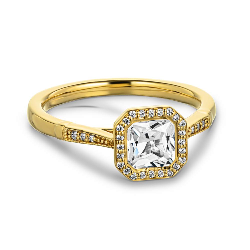 Shown with a 1ct Radiant cut Lab Grown Diamond in 14k Yellow Gold|Vintage style halo engagement ring with accenting diamonds and milgrain detailing and a 1ct radiant cut lab created diamond in 14k yellow gold