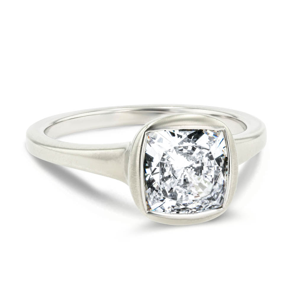 Shown in 14K White Gold with a Satin Finish|bezel set satin finish engagement ring with cushion cut lab grown diamonds