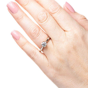 Unique two tone solitaire engagement ring with inlay braided rope design set with 1ct round cut lab grown diamond in 14k white gold and rose gold worn on hand