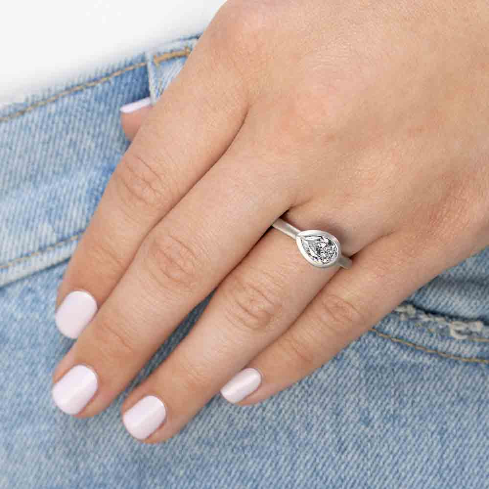Shown in 14K White Gold with a Satin Finish|bezel set satin finish engagement ring with pear cut east to west lab grown diamonds