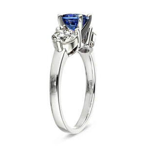 Three stone engagement with round cut lab grown diamonds and lab created blue sapphire center stone in 14k white gold side view
