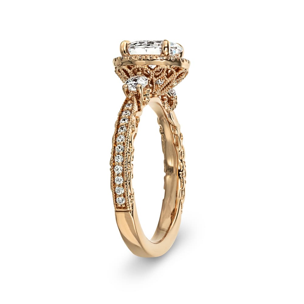 Shown with 1.5ct Oval Cut Lab Grown Diamond in 14k Rose Gold|Vintage rose gold engagement ring with diamond halo surrounding a 1.5ct oval lab grown diamond secured with claw prongs