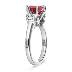 Three stone engagement ring with 1ct oval cut lab created ruby and half moon cut diamond simulant side stones in 14k white gold shown from side