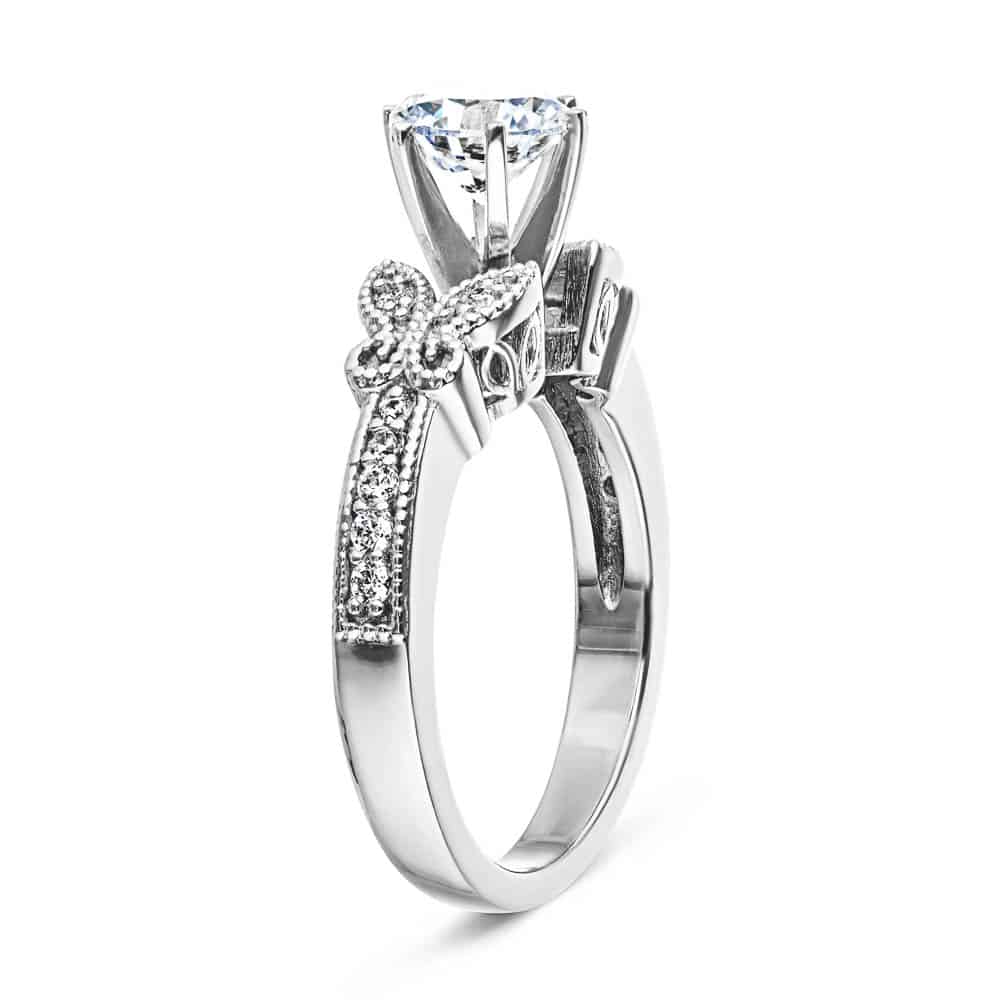 Shown with 1ct Round Cut Lab Grown Diamond in 14k White Gold|Vintage style butterfly engagement ring with diamond accented milgrain detail band holding 1ct round cut lab grown diamond in 14k white gold