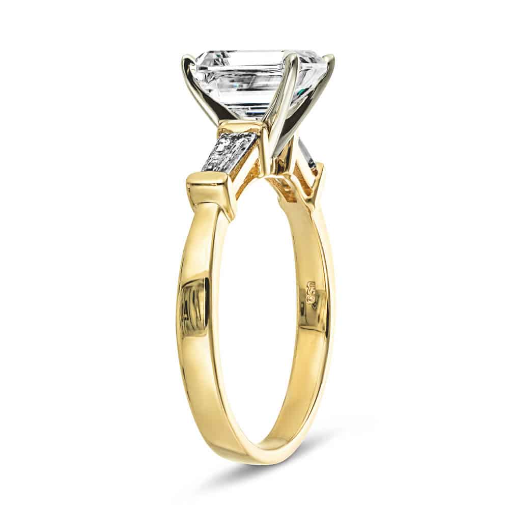 Shown with 1ct Emerald Cut Lab Grown Diamond in 14k Yellow Gold|Modern three stone engagement ring with two baguette cut recycled diamond side stones and a 1ct emerald cut lab grown diamond center in 14k yellow gold