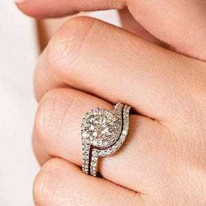 Wavy Diamond accented engagement ring with matching wedding band shown worn on hand as set
