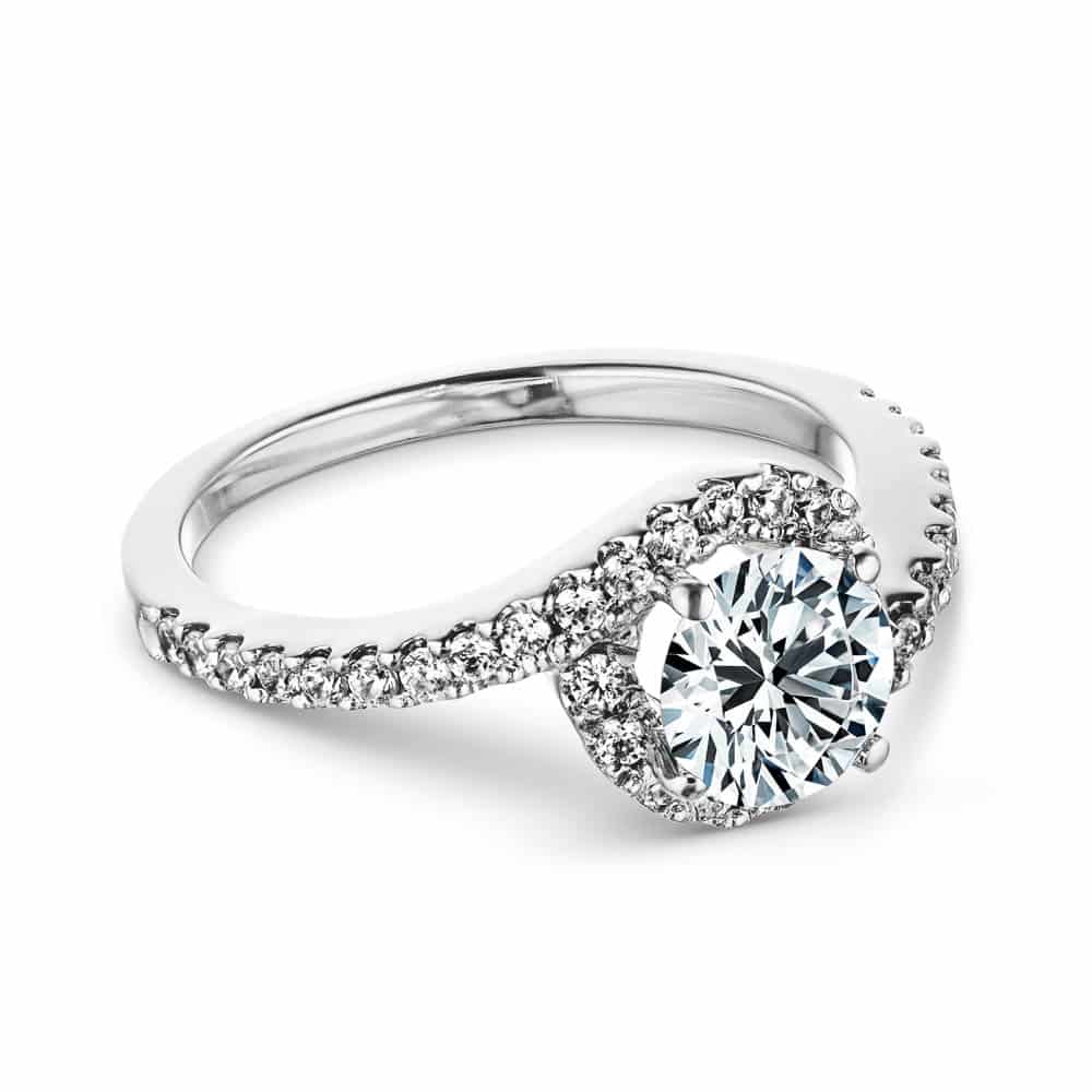 Shown with a 1.0ct Round cut Lab-Grown Diamond with recycled accenting diamond halo and band in recycled 14K white gold  
