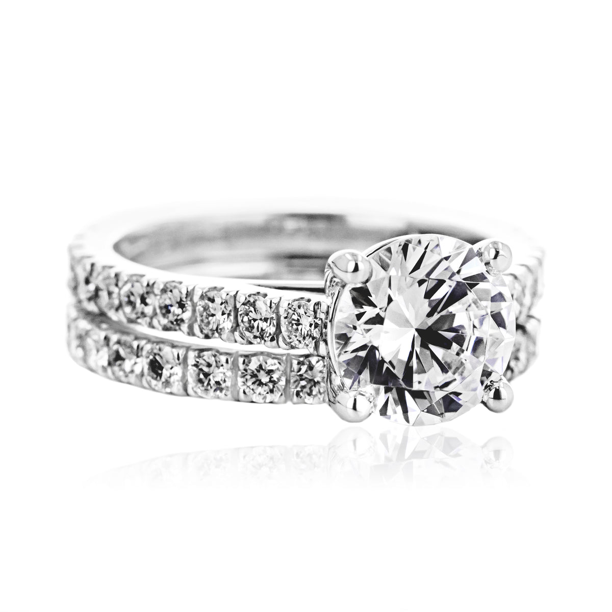 Shown with 1ct Round Cut Lab Grown Diamond in 14k White Gold with Matching Wedding Band