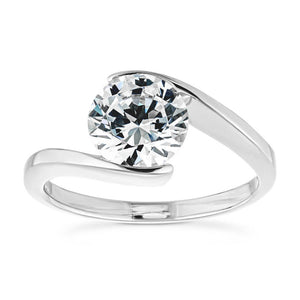 Modern minimalistic sleek engagement ring with a 2ct round cut lab grown diamond in a 14k white gold band that gives the illusion of a tension setting
