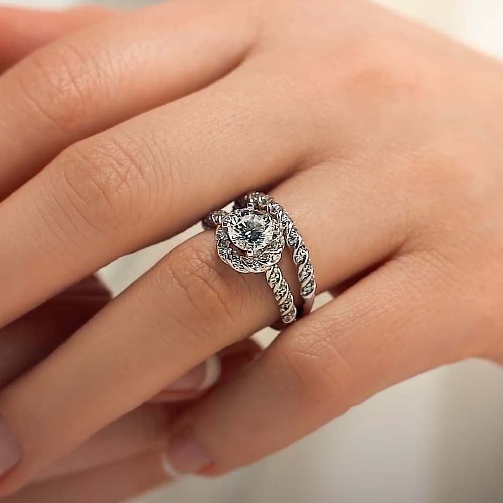 Shown with a 1.0ct Round cut Lab-Grown Diamond with diamond entwined halo and band in recycled 14K white gold with matching wedding band| engagement ring diamond accented halo and band 1.0ct round cut lab-grown diamond in recycled 14k white gold with matching band