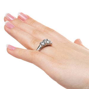 Three stone engagement ring with round cut lab grown diamonds in 14k white gold worn on hand sideview