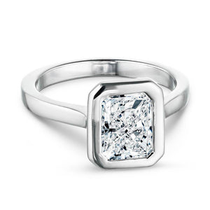 Modern white gold engagement ring with 1ct radiant cut bezel set lab grown diamond