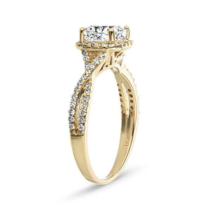 Diamond halo engagement ring with crossover split shank band set with 1ct cushion cut lab grown diamond in 14k yellow gold shown from side