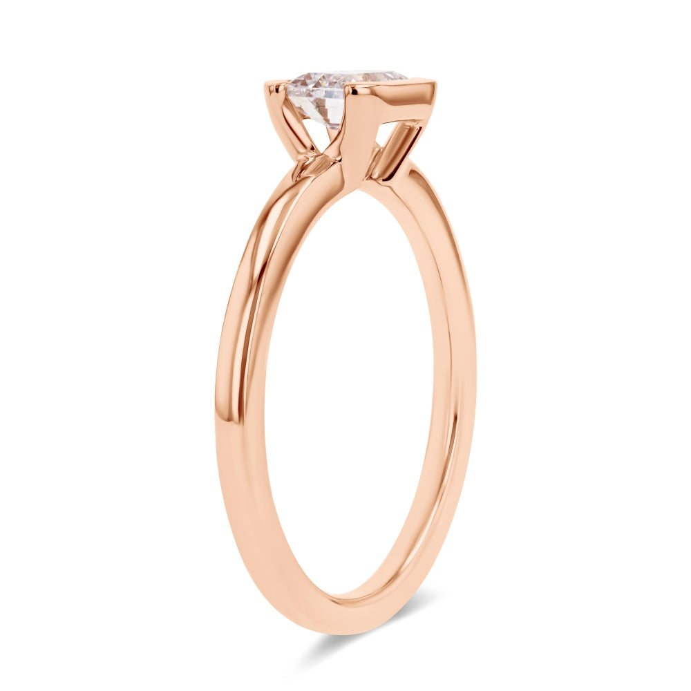 Shown here with a 0.75ct Emerald Cut Lab Grown Diamond center stone in 14K Rose Gold|semi bezel solitaire engagement ring with east to west emerald cut center stone set in 14k rose gold