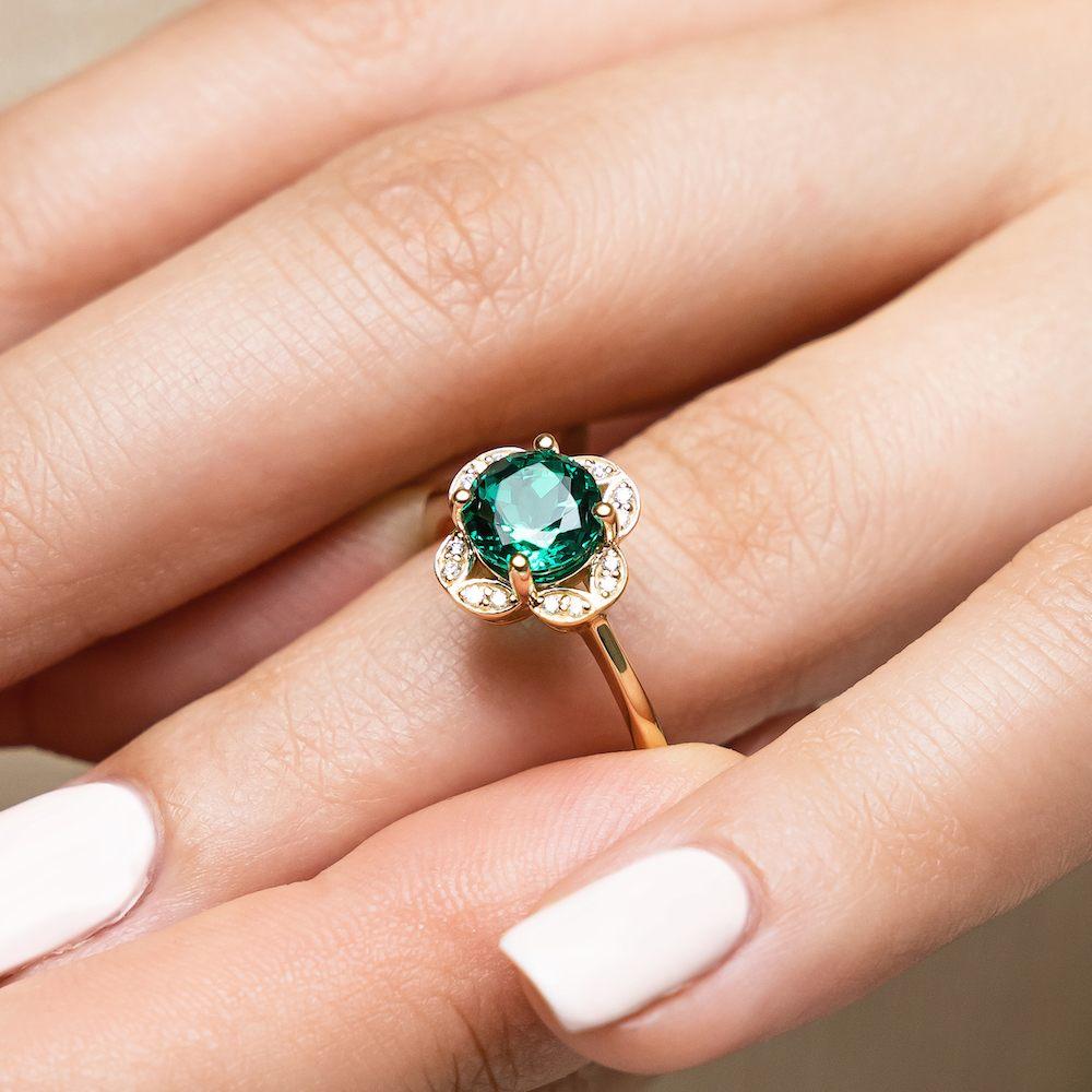 Shown with 1ct round cut lab created emerald in 14k yellow gold