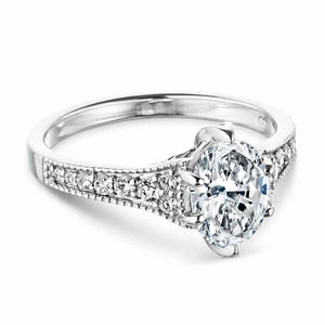 Vintage style diamond accented engagement ring with 6 prong set 1ct oval cut lab grown diamond in a milgrain detailed 14k white gold band