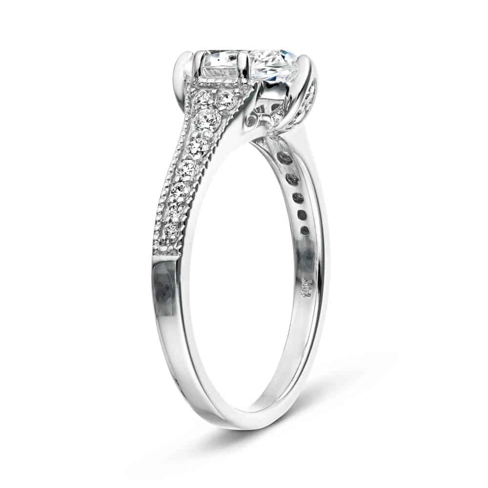 Shown with a 1.0ct Oval cut Lab-Grown Diamond with filigree detail and accenting diamonds on the band in recycled 14K white gold 