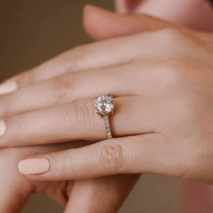 Diamond accented engagement ring with 1.5ct round cut lab grown diamond in platinum shown worn on hand