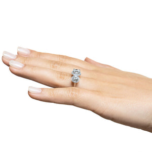 Three stone triple halo engagement ring with round cut lab grown diamonds in 14k white gold shown worn on hand sideview