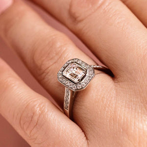 Beautiful vintage style diamond accented halo engagement ring with 1ct emerald cut lab grown diamond in 14k white gold worn on hand