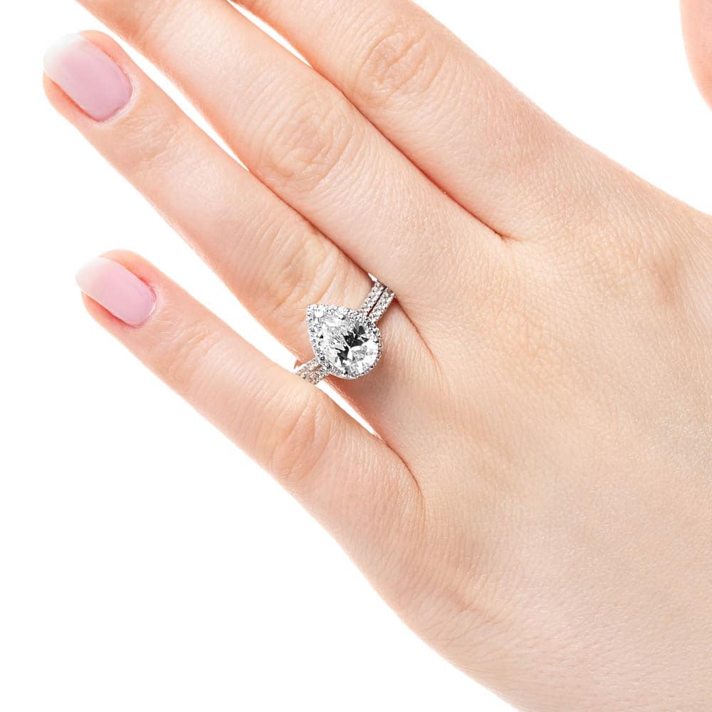 Shown with a 1.91ct Pear cut Lab-Grown Diamond in recycled 14K white gold with matching wedding band
