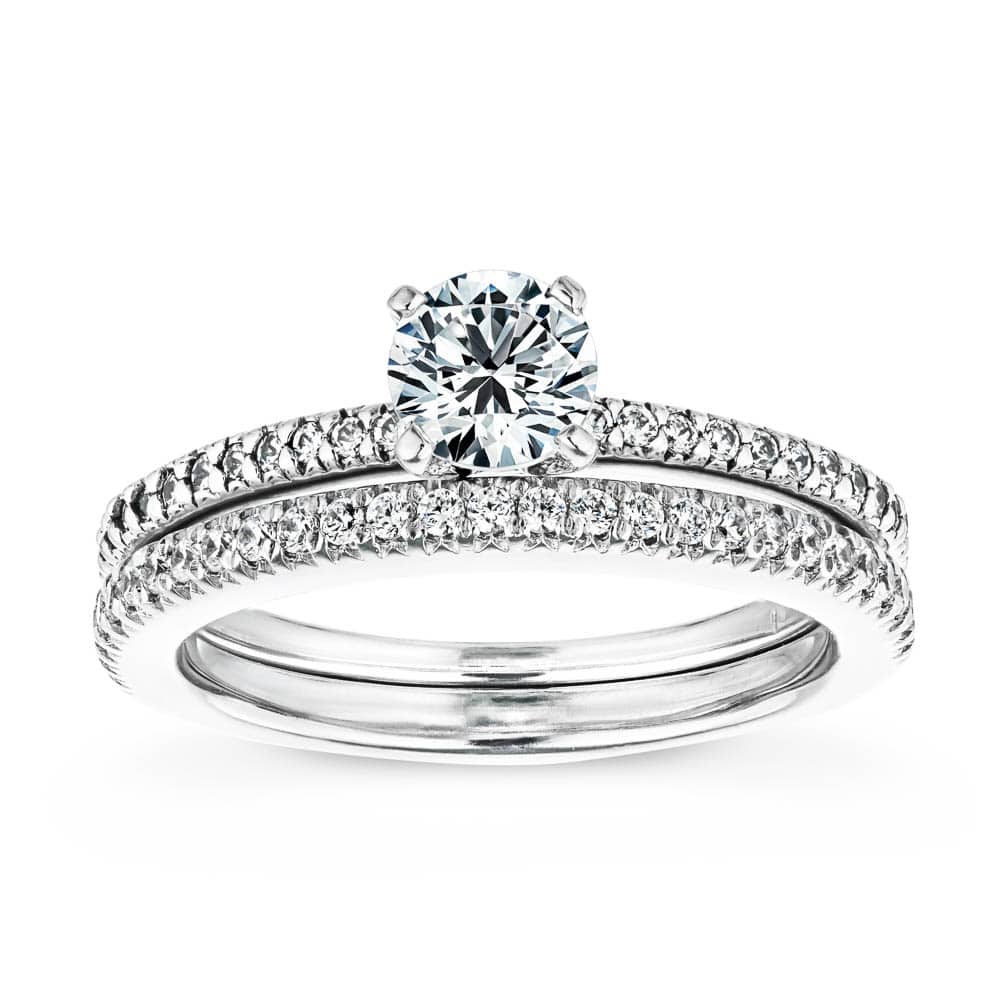 Shown with a 1.0ct Round cut Lab-Grown Diamond with a diamond accented band in recycled 14K white gold with matching wedding band 