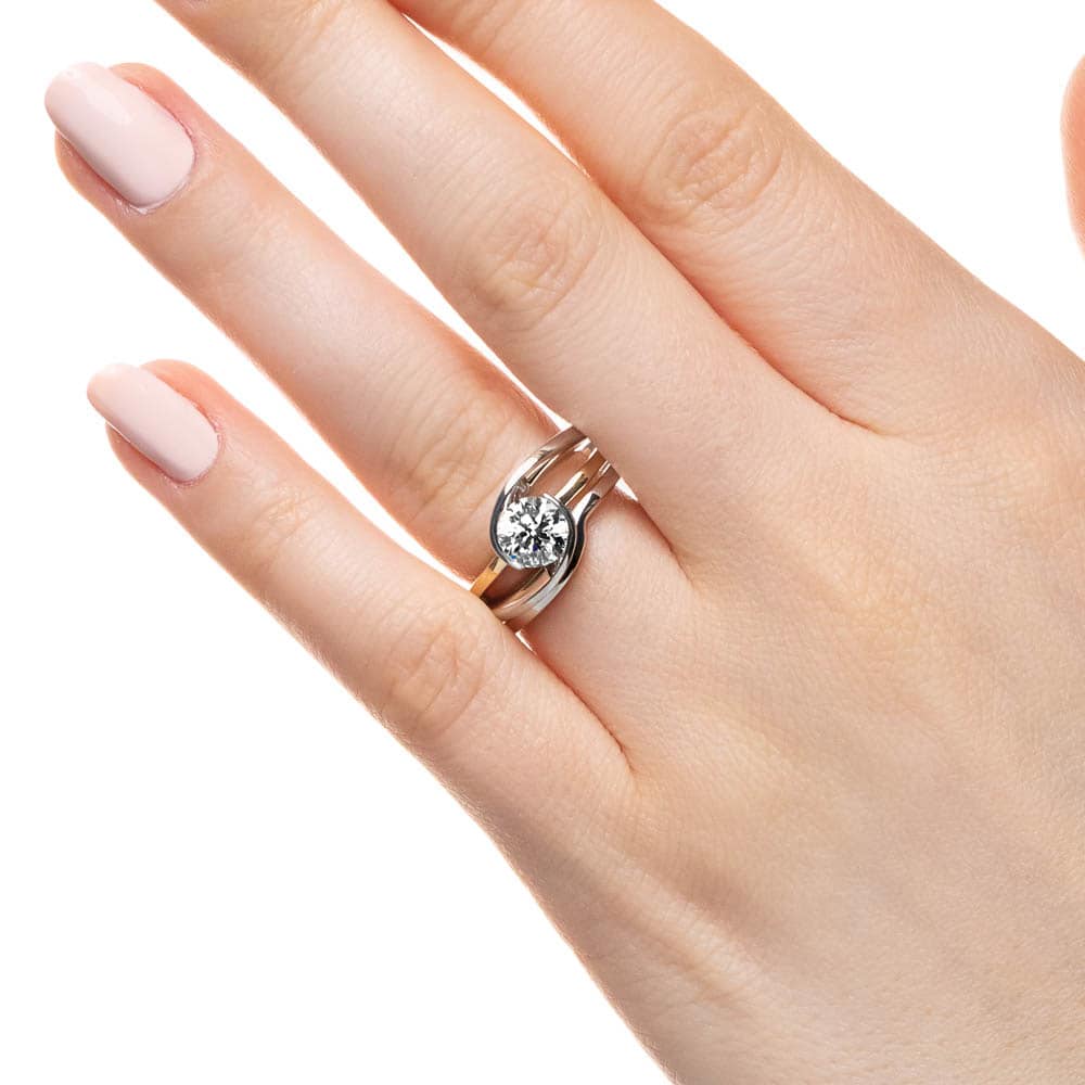 Shown with a 1.45ct Round cut lab-grown diamond in recycled 14K white gold with matching wedding band 