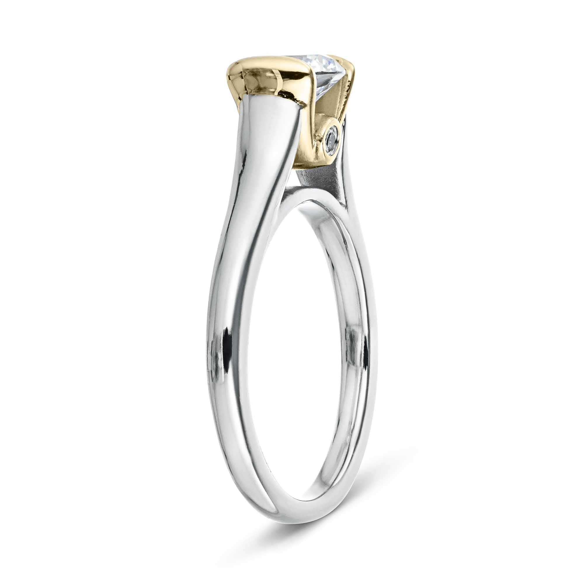 Shown with 1ct Round Cut Lab Grown Diamond in 14k White Gold and 14K Yellow Gold|Unique modern solitaire two tone engagement ring with half bezel set 1ct round cut lab grown diamond above a peek-a-boo diamond in 14k white gold and 14k yellow gold