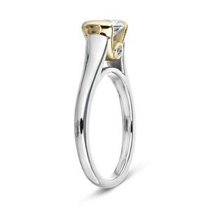 Unique modern solitaire two tone engagement ring with half bezel set 1ct round cut lab grown diamond above a peek-a-boo diamond in 14k white gold and 14k yellow gold