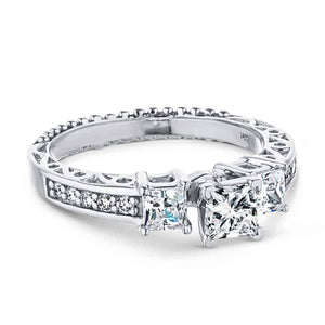 Vintage style three stone engagement ring with princess cut lab grown diamonds and antique style scroll detailing in 14k white gold