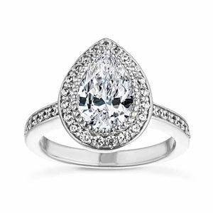 Celebrity inspired diamond accented halo engagement ring with channel set diamond accented 14k white gold band and a 1ct pear cut center stone