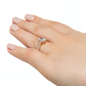 Vintage style three stone diamond accented engagement ring with filigree detailed band featuring 1ct oval lab grown diamond in 14k rose gold