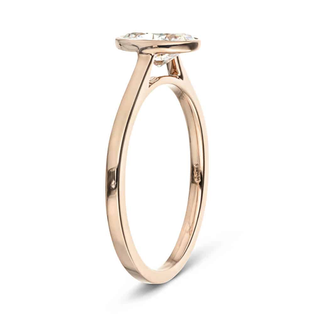 Shown with 1ct oval cut lab grown diamond in 14k rose gold|Minimalistic sleek modern flat design stackable engagement ring with 1ct bezel set oval cut lab grown diamond in 14k rose gold