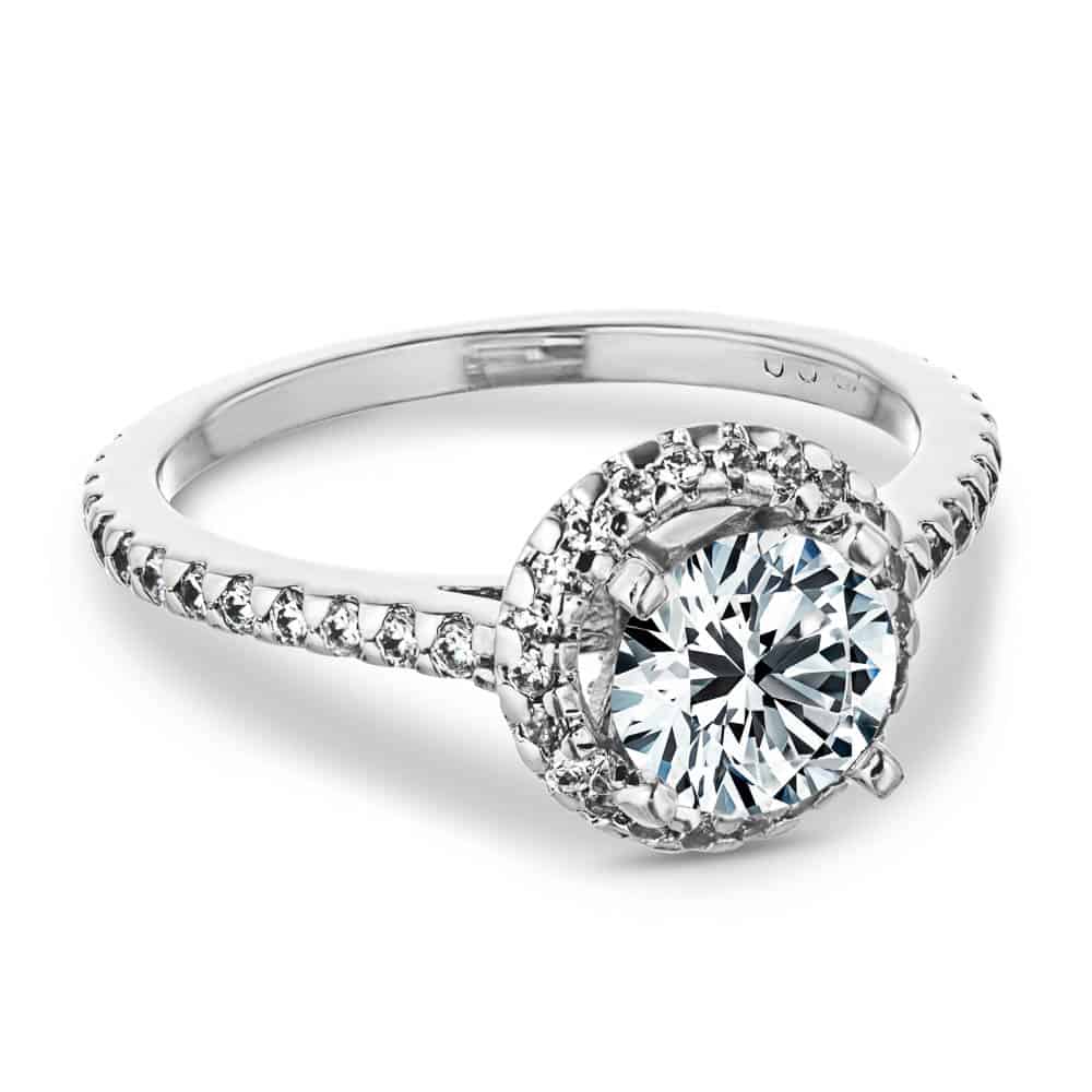 Shown with a 1.0ct Round cut Lab-Grown Diamond with a diamond accented halo and band in recycled 14K white gold 