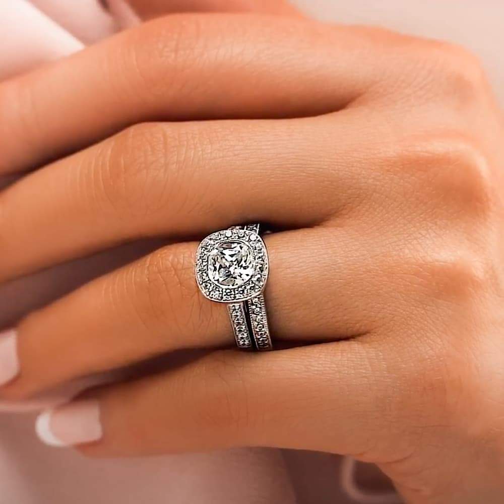 Shown with a 1.0ct Cushion cut Lab-Grown Diamond with a diamond accented and filigree detailed halo and accenting diamonds on the band in recycled 14K white gold with matching band, purchase the set together for a discount | antique vintage engagement ring Shown with a 1.0ct Cushion cut Lab-Grown Diamond with a diamond accented and filigree detailed halo and accenting diamonds on the band in recycled 14K white gold with matching wedding band