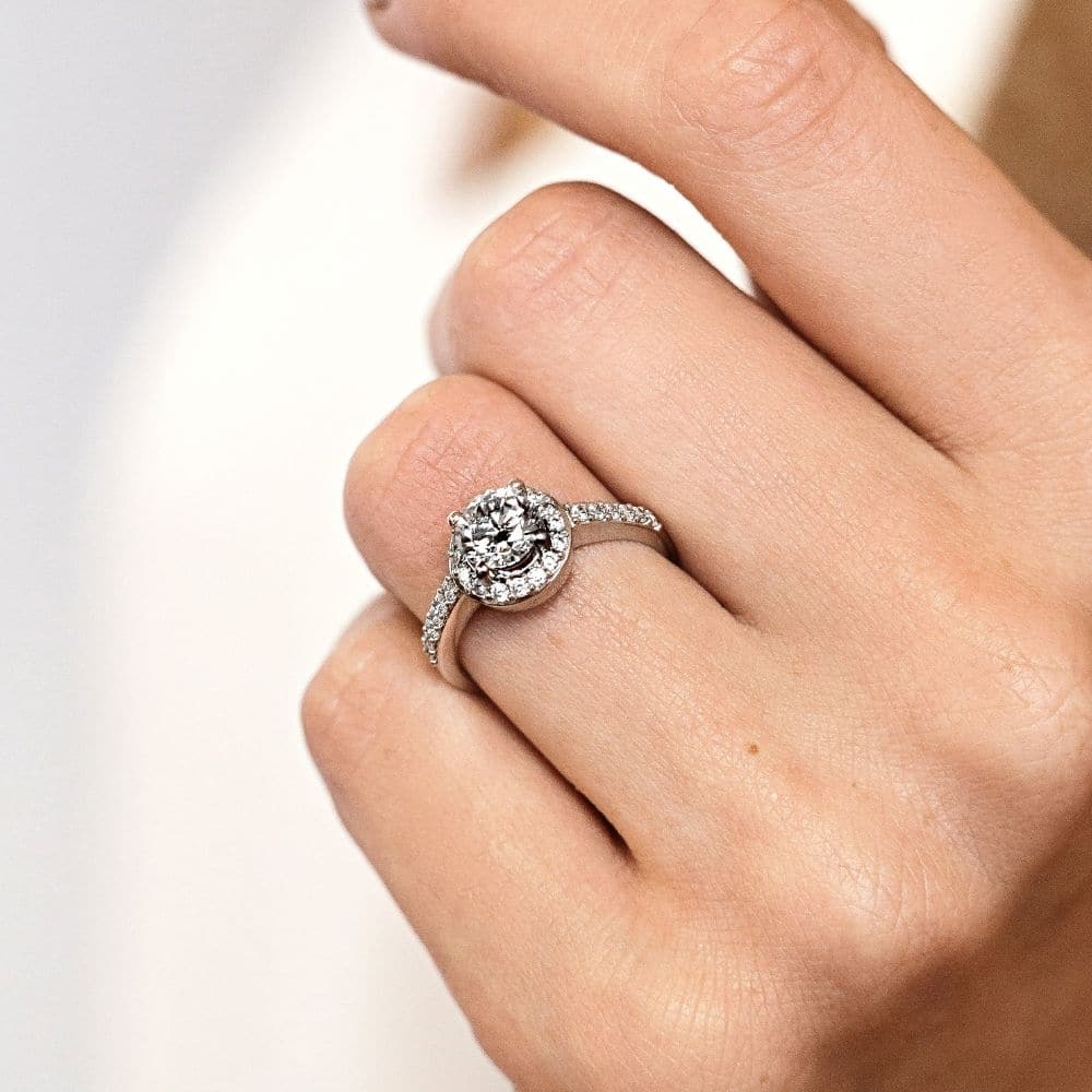 Shown with 0.5ct Round Cut Lab Grown Diamond in 14k White Gold|Unique channel set diamond accented halo engagement ring with 0.5ct round cut lab grown diamond in 14k white gold