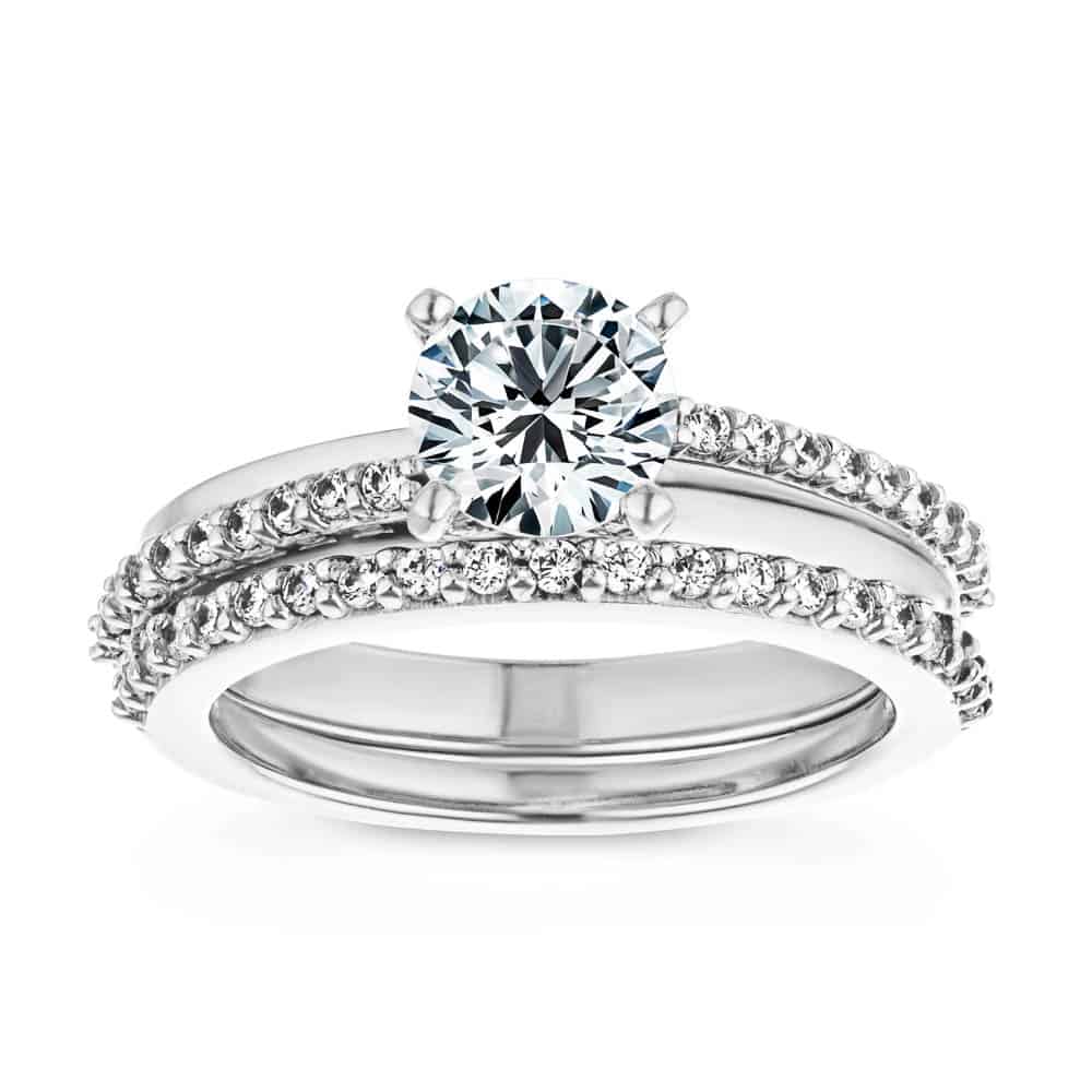 Shown with a 1.0ct Round cut Lab-Grown Diamond with accenting diamonds on the band in recycled 14K white gold with matching band, can be purchased together at a discounted price 