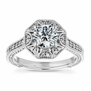 Unique antique style diamond accented halo engagement ring with filigree and milgrain detailing holding a 1ct round cut lab grown diamond in 14k white gold