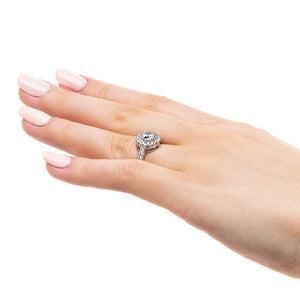 Diamond accented halo engagement ring with 1ct round cut lab grown diamond in 14k white gold worn on hand sideview