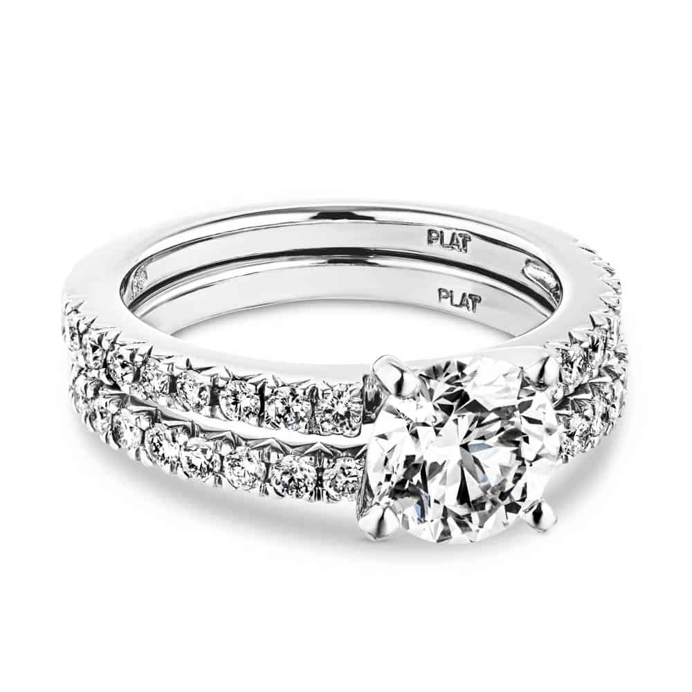 Shown with a 1.0ct Round cut Lab-Grown Diamond with a diamond accented band in recycled platinum with matching band, can be purchased as a set at a discounted price 