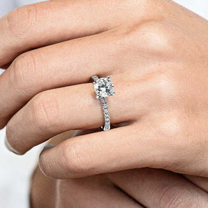 Ethical affordable diamond accented engagement ring with 1ct round cut lab created diamond center stone in 14k white gold worn on hand
