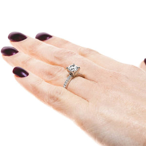 Diamond accented engagement ring with 1ct round cut lab grown diamond in platinum setting worn on hand sideview