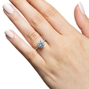 Diamond accented engagement ring with 1ct round cut lab grown diamond in 14k white gold band worn on hand